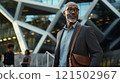 Waist up portrait of African American professor wearing glasses looking away while standing outside modern campus building with geometric design copy space 121502967