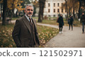 Waist up portrait of classic senior university professor with gray hair and beard wearing tweed suit and looking at camera standing in campus copy space 121502971