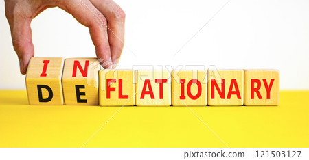 Deflationary or inflationary symbol. Concept words Deflationary Inflationary on wooden blocks. Beautiful white background. Businessman hand. Business deflationary inflationary concept. Copy space Deflationary or inflationary symbol. Concept words Deflationary Inflationary on wooden blocks. Beautiful white background. Businessman hand. Business deflationary inflationary concept. Copy space 121503127