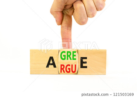 Agree or argue symbol. Concept words Agree or Argue on wooden block. Beautiful white table white background. Businessman hand. Business agree or argue concept. Copy space. Agree or argue symbol. Concept words Agree or Argue on wooden block. Beautiful white table white background. Businessman hand. Business agree or argue concept. Copy space. 121503169