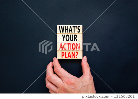 Action plan symbol. Concept words What is your action plan on beautiful wooden blocks. Beautiful black table black background. Businessman hand. Business What is your action plan concept. Copy space Action plan symbol. Concept words What is your action plan on beautiful wooden blocks. Beautiful black table black background. Businessman hand. Business What is your action plan concept. Copy space 121503201