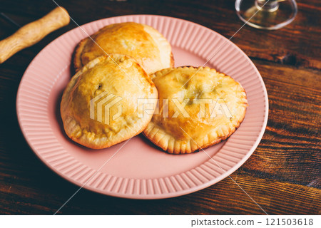 Three Oven Baked Pies Filled with Chives and Mushrooms on Plate Three Oven Baked Pies Filled with Chives and Mushrooms on Plate 121503618