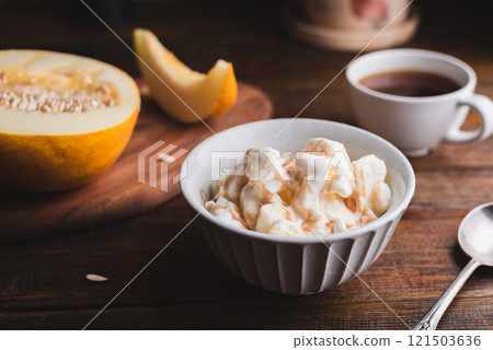 Melon Ice Cream with Fruit Syrup in Bowl 121503636
