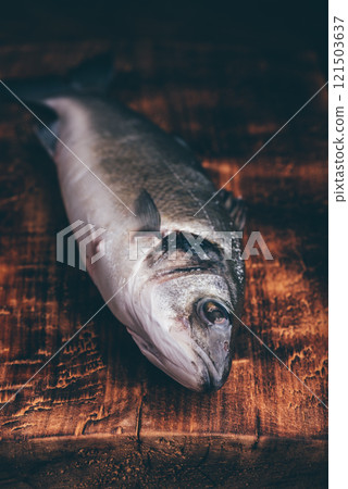 Freshly Caught Sea Bass on Wooden Surface 121503637