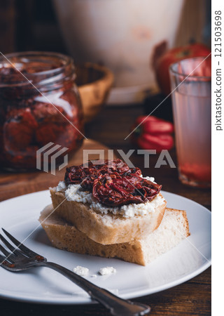 White bread with sun-dried tomatoes and cream cheese White bread with sun-dried tomatoes and cream cheese 121503698