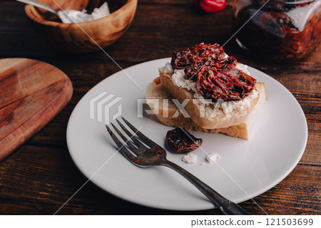 Snack with sun-dried tomatoes and cream cheese Snack with sun-dried tomatoes and cream cheese 121503699