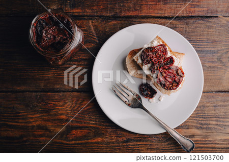 Toasts with cottage cheese and sun-dried tomatoes on a wooden table Toasts with cottage cheese and sun-dried tomatoes on a wooden table 121503700
