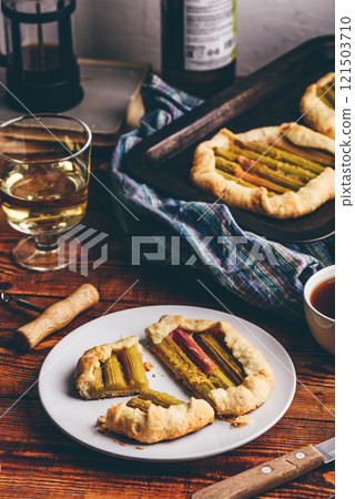Rhubarb galette on plate with glass of wine Rhubarb galette on plate with glass of wine 121503710
