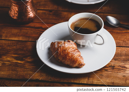 Cup of Black Coffee and Fresh Croissant 121503742