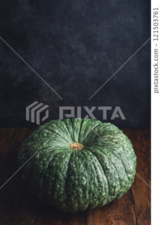 Big green pumpkin on table 121503761