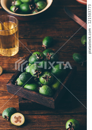 Pineapple guavas in a small box on a wooden table Pineapple guavas in a small box on a wooden table 121503773
