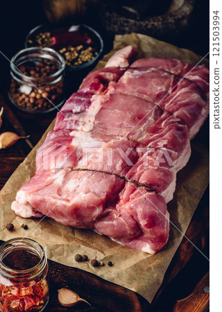 Raw pork loin joint with different spices 121503994