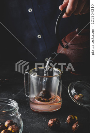 Steeping red tea in glass mug Steeping red tea in glass mug 121504310
