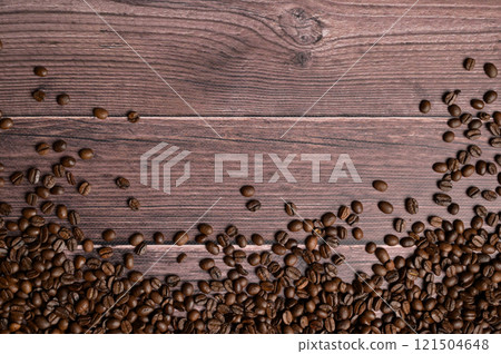 Top view roasted coffee beans on wooden table. Copy space background, cover, backdrop, texture. Place for adding text or design Top view roasted coffee beans on wooden table. Copy space background, cover, backdrop, texture. Place for adding text or design 121504648