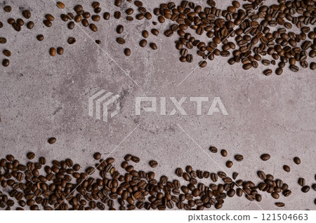 Top view above and below roasted coffee beans on gray concrete. Copy space background, cover, backdrop, texture. Place for adding text or design 121504663