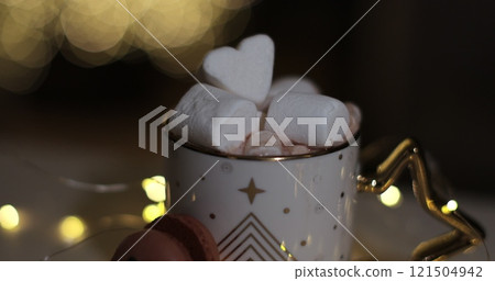 Hot chocolate with marshmallow and cookie on a Christmas background. Hot chocolate with marshmallow and cookie on a Christmas background. 121504942