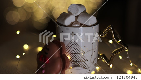Hot chocolate with marshmallow and cookie on a Christmas background. Hot chocolate with marshmallow and cookie on a Christmas background. 121504943