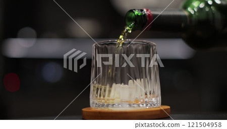 Pour whiskey into glass on background. Hand man pouring whiskey into crystal glass. Pour whiskey into glass on background. Hand man pouring whiskey into crystal glass. 121504958