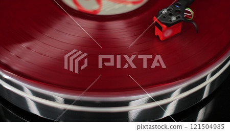 Classic vinyl record player close-up. Retro vinyl record player spins an LP disc. Classic vinyl record player. 121504985