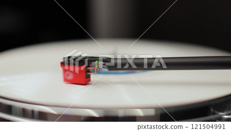 Classic vinyl record player close-up. Retro vinyl record player spins an LP disc. Classic vinyl record player. 121504991