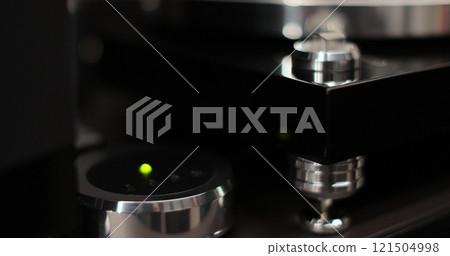 A man turns on a vinyl record player. Vintage style atmosphere. A man turns on a vinyl record player. Vintage style atmosphere. 121504998