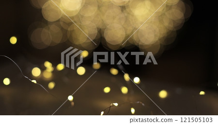 Woman puts cocoa with marshmallows on table. Christmas lights background. Woman puts cocoa with marshmallows on table. Christmas lights background. 121505103