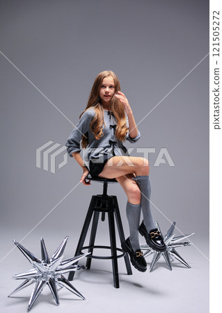 A Sleek and Stylish Fashion Shoot Featuring a Young Model Surrounded by Decorative Elements A Sleek and Stylish Fashion Shoot Featuring a Young Model Surrounded by Decorative Elements 121505272