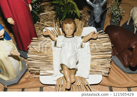Baby Jesus laying in a cradle 121505429