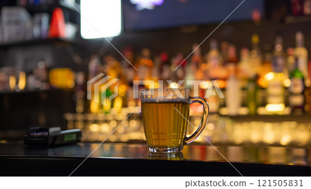 A mug of beer on the bar counter in a pub. 121505831