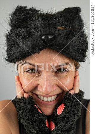Portrait of a woman in a cat costume on a white background. Quadrober. Vertical photo. Portrait of a woman in a cat costume on a white background. Quadrober. Vertical photo. 121505834