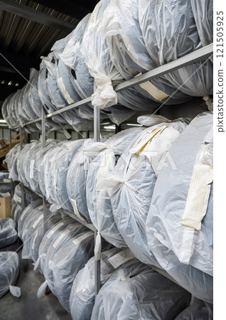 New car tires in plastic bags in a store.  121505925