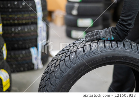 Mechanic keeps new studded car tires in garage.  121505928