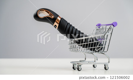 Sex toy in miniature shopping cart on white background.  121506002