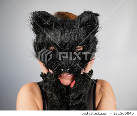 Portrait of a woman in a cat costume on a white background. Quadrober. Portrait of a woman in a cat costume on a white background. Quadrober. 121506040