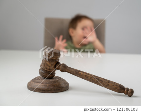 Little boy behind judge's gavel.  121506108
