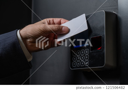 A man opens the door with a card. Modern electronic lock. Keyless Entry 121506482