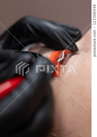 Caucasian woman undergoing eyelash lamination procedure. Caucasian woman undergoing eyelash lamination procedure. 121506548