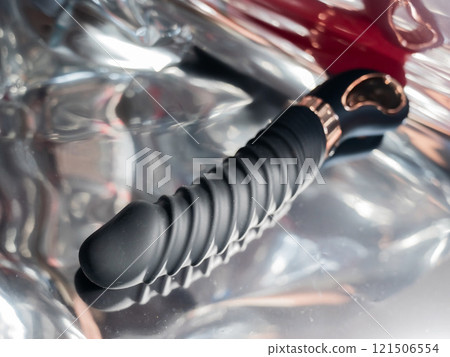 Sex toy on metal background.  121506554