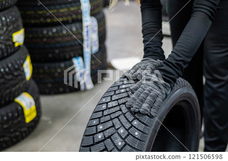 Mechanic keeps new studded car tires in garage. Mechanic keeps new studded car tires in garage. 121506598