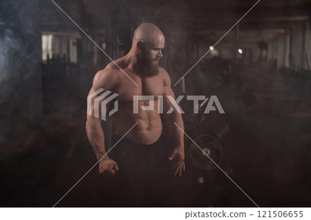 Caucasian bald man posing in the gym. 121506655