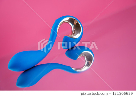 Blue sex toy on mirrored pink surface.  121506659