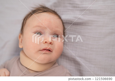 Top view of a newborn baby wearing an orthopedic collar. Top view of a newborn baby wearing an orthopedic collar. 121506690