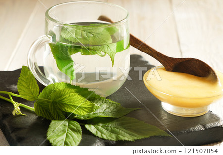raspberry leaves Tea with Fresh Leaves and Honey on Slate Board 121507054