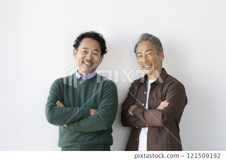 Two senior men smiling at the camera 121509192