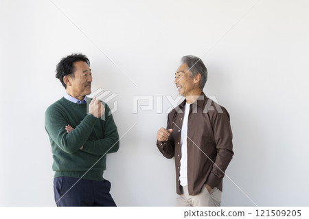 Two senior men smiling and chatting Two senior men smiling and chatting 121509205