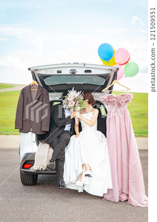 Bride and groom/couple taking wedding photos in a car wedding/bridal car Bride and groom/couple taking wedding photos in a car wedding/bridal car 121509551