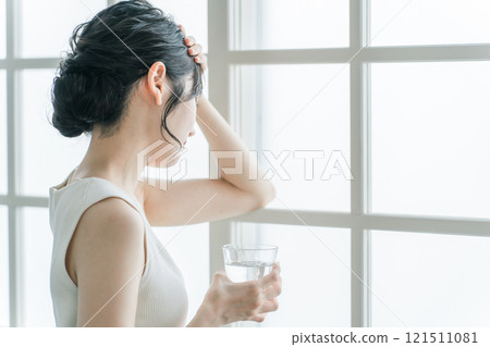 Asian woman suffering from headache, stress, depression, cold, feeling unwell, dizziness and fatigue 121511081