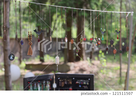 A Colorful Jewelry Display Hanging Beautifully in Nature for All to Admire and Enjoy A Colorful Jewelry Display Hanging Beautifully in Nature for All to Admire and Enjoy 121511507