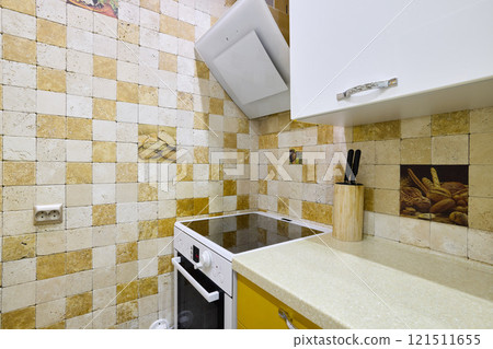 A Cozy Kitchen that features Modern Appliances along with Beautiful Decorative Tiles A Cozy Kitchen that features Modern Appliances along with Beautiful Decorative Tiles 121511655