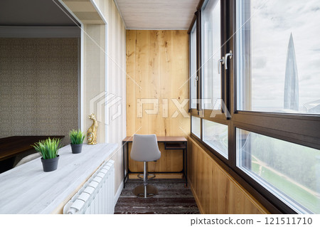 A modern home office space bathed in natural light and featuring a minimalistic design approach A modern home office space bathed in natural light and featuring a minimalistic design approach 121511710